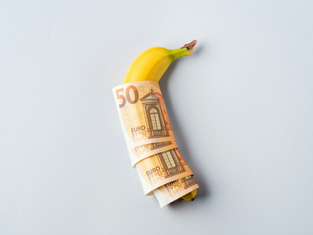 Euro banknotes 50 value with banana on gray background